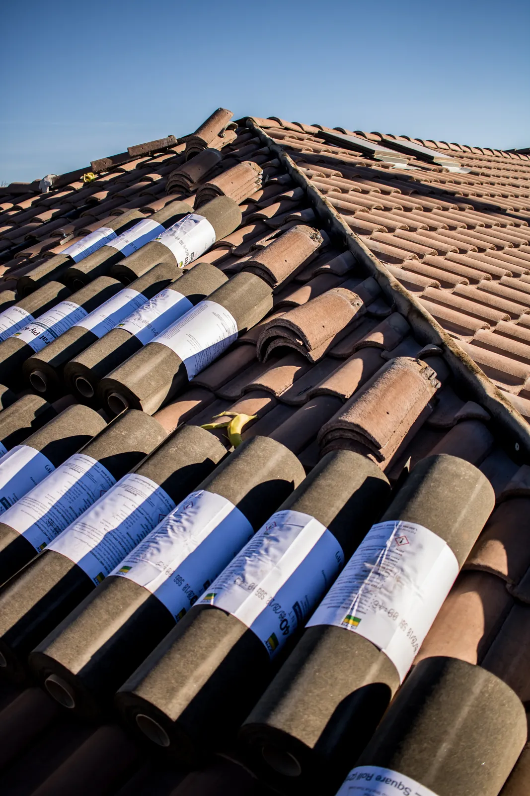 Clay roof tiles staged on a roof for a tile roof repair in Arizona